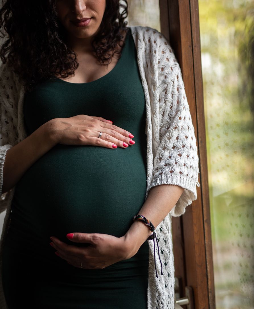 Happy pregnant mother smiling, enjoying comfortable pregnancy with chiropractic care