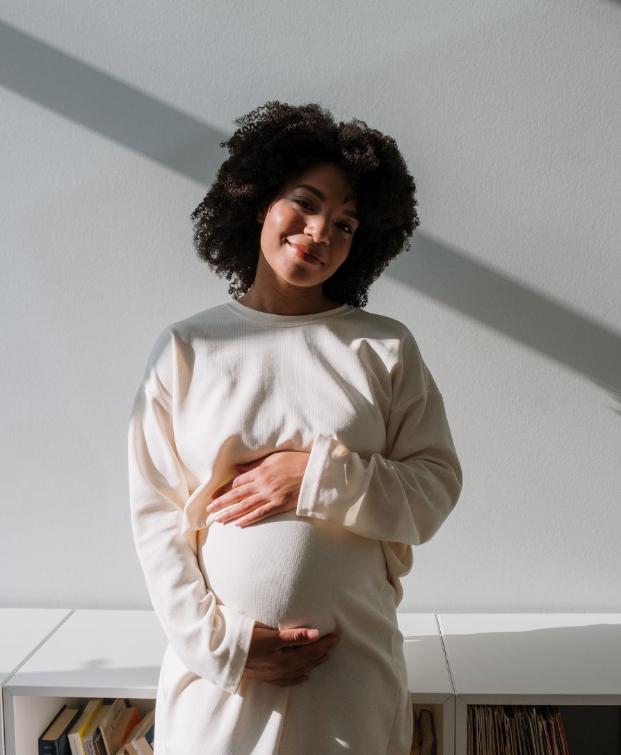 Happy pregnant woman with baby