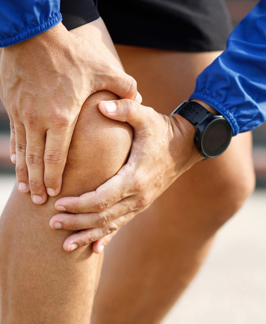 Patient experiencing knee joint pain from arthritis receiving chiropractic examination