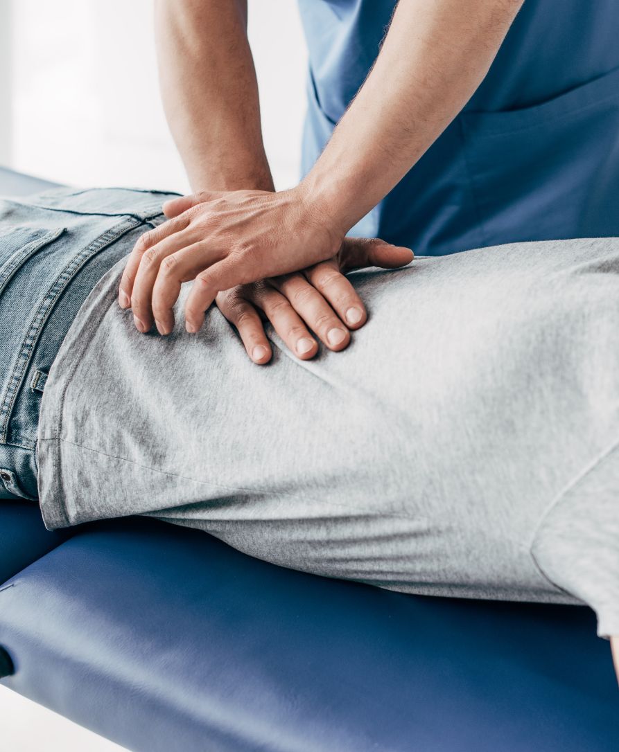 Chiropractor providing spinal adjustment to University of Arkansas student near Fayetteville campus and Dickson Street