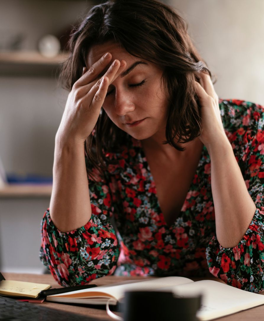 Woman experiencing severe migraine headache pain in need of chiropractic care