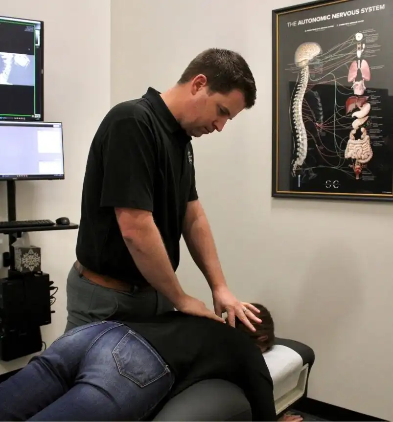 Dr. Stinson performing precise spinal adjustment on patient at Springdale chiropractic office