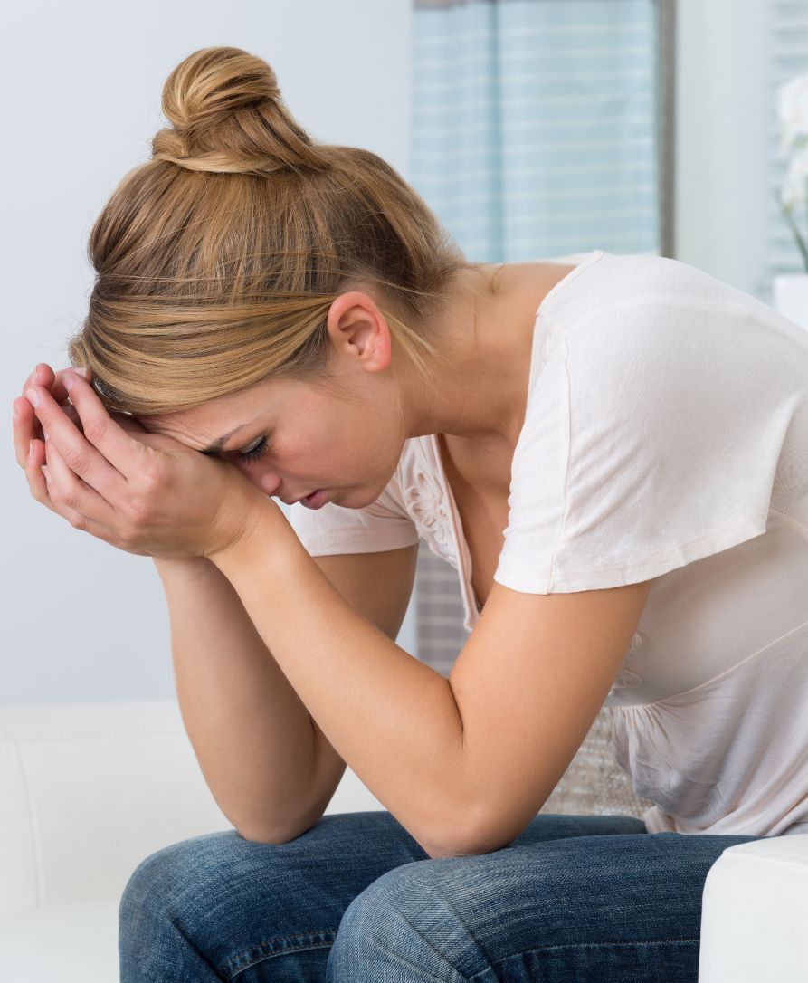 Woman experiencing stress and tension in neck and shoulders needing chiropractic relief